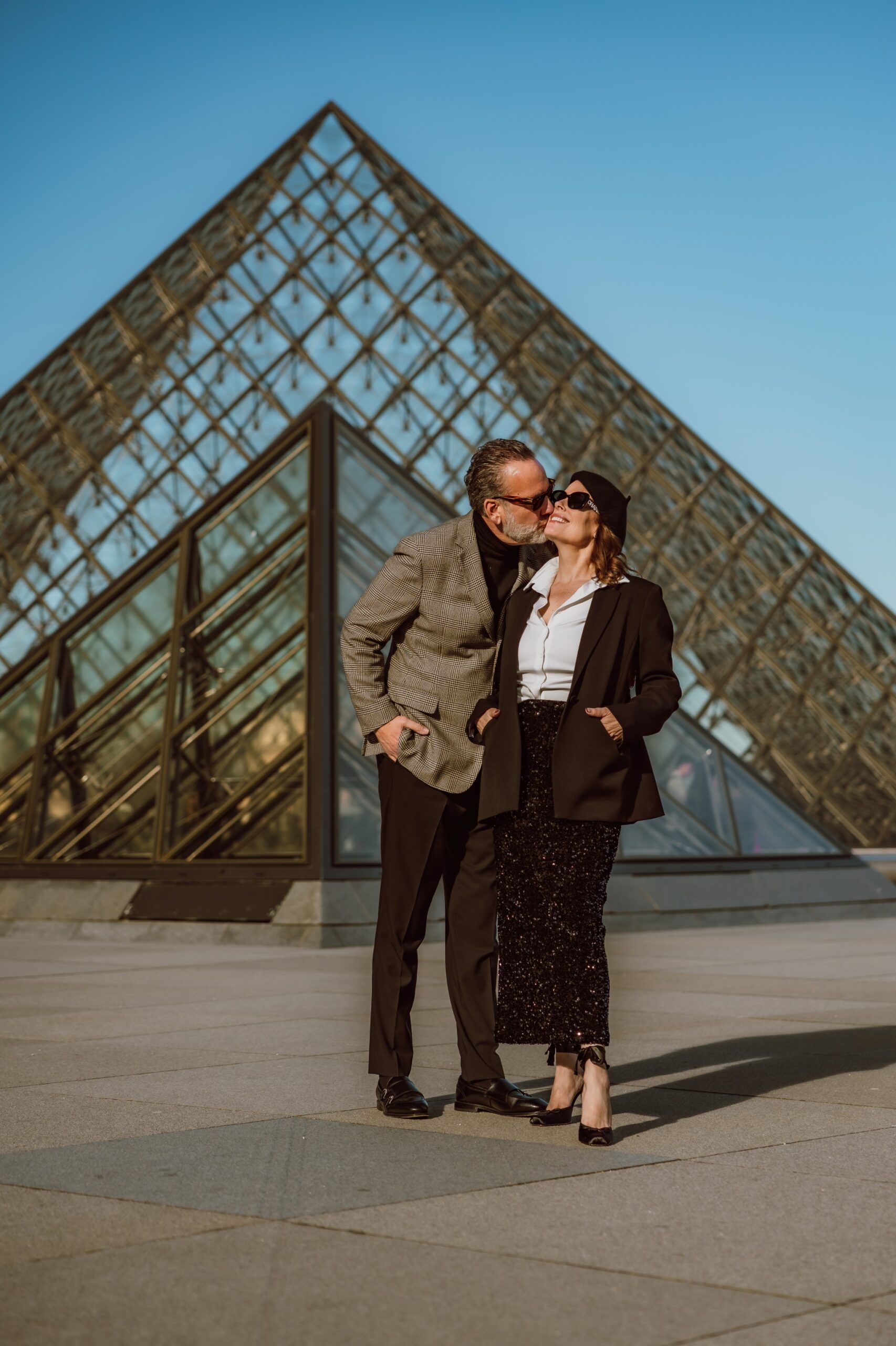 Stylish couple senior photoshoot Paris Louvre pyramid